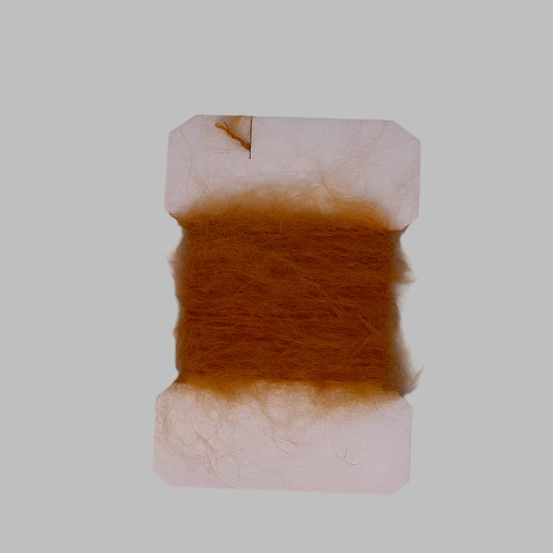 Leech mohair yarn tuft on card, burnt orange