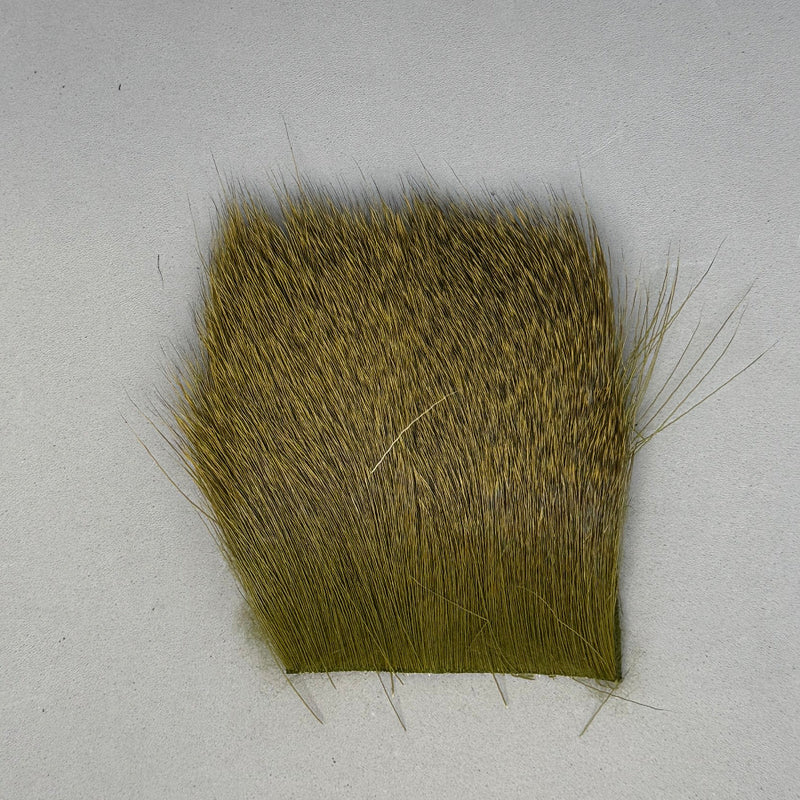 Deer short fine hair swatch in olive green with short, fine strands