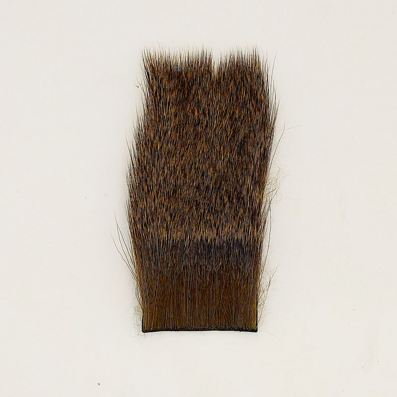 Nature's Spirit deer hair stimulator, rectangular dark brown hair pad with dense bristles.