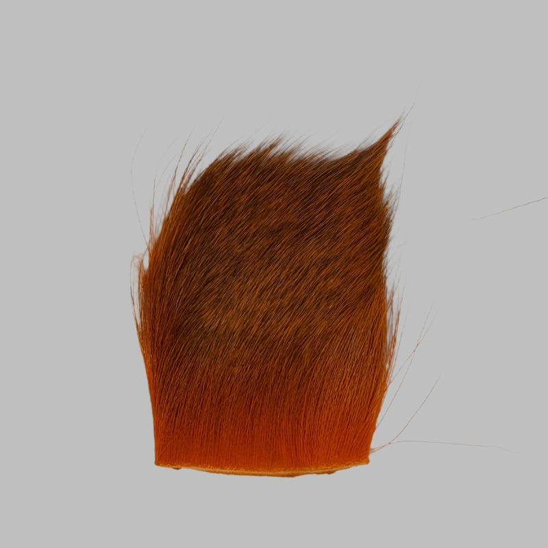 Orange deer hair patch with dense fibers and slightly lighter bottom