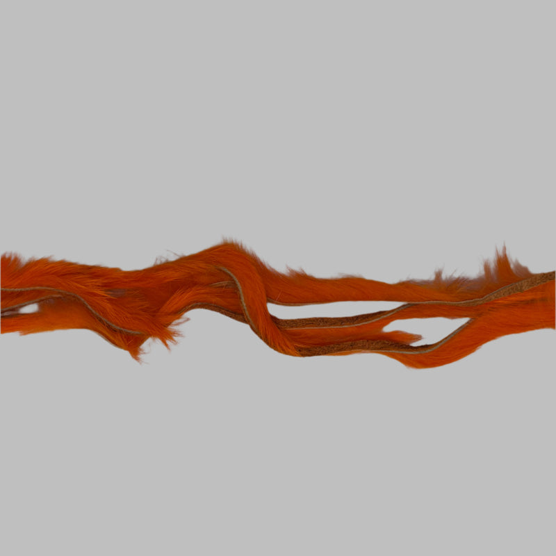 Zonker strips in orange, long wavy fur strip with exposed underside holes