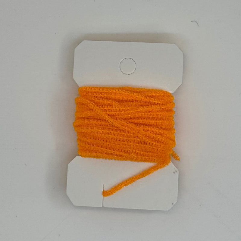 Chenille thread spool on card in bright orange with short yarn tail
