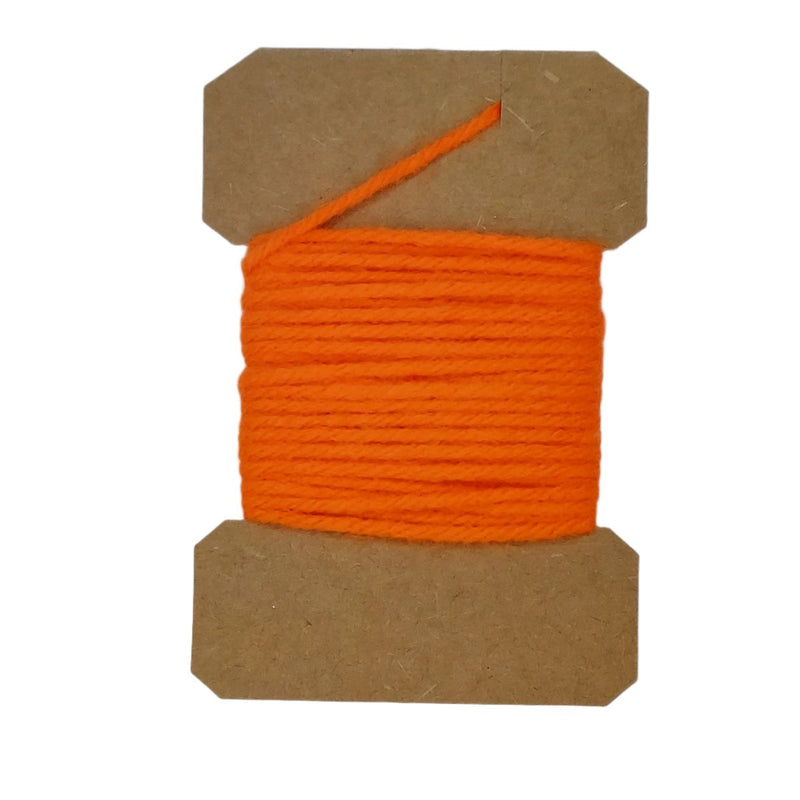 Wool yarn spool with orange yarn wrapped on brown cardboard core.