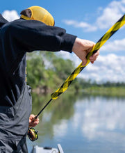 Striped rod sleeve in yellow and black on fishing rod handle during casting