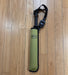 A REC brand wading staff folded and in its olive sheath with a black handle and retractor, lying on a light brown wooden floor. The REC logo is clearly visible on both the sheath and the retractor.