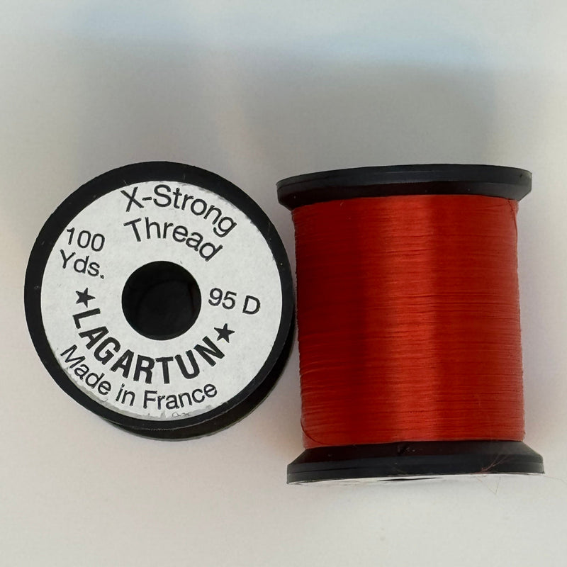 Red thread spool with winding and circular label