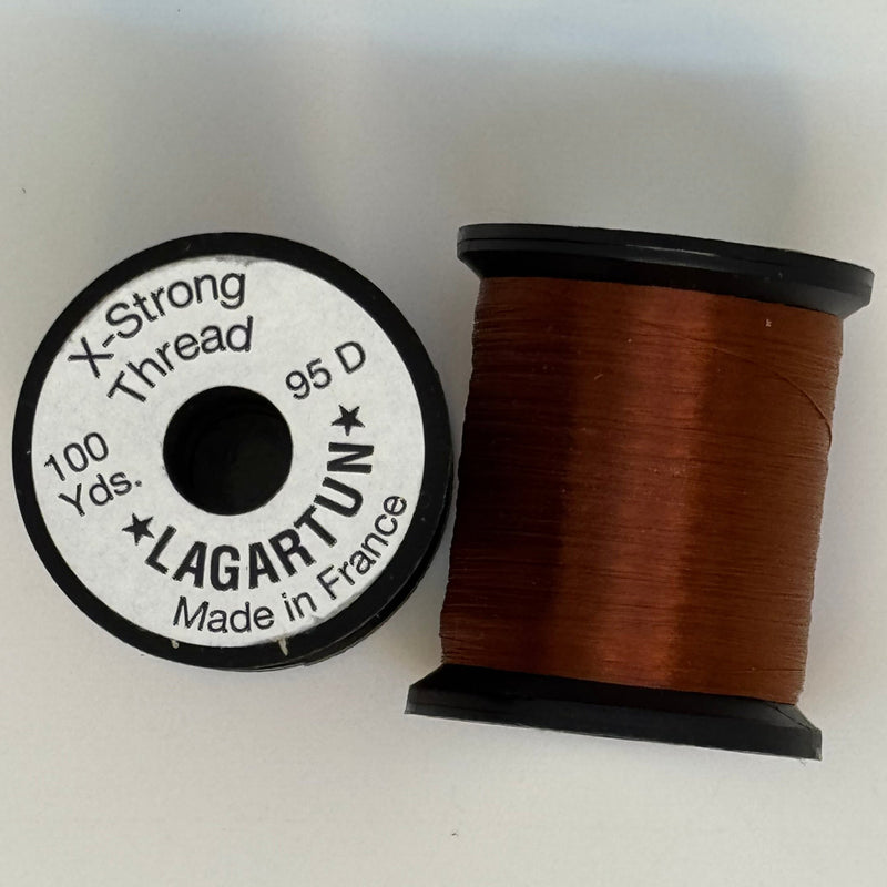 Brown thread spool with winding and circular label