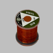 Spool of vinyl rib trim in rust orange with coiled strand
