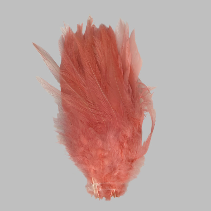 Strung rooster saddle feathers, salmon-pink with frilly barbs and quills.