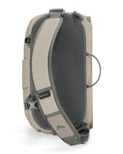 Simms sling pack side view, beige back panel with dark mesh and shoulder strap