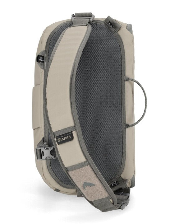 Simms sling pack side view, beige back panel with dark mesh and shoulder strap
