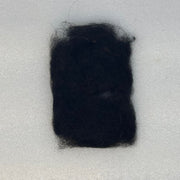 Black dubbing fibers clump