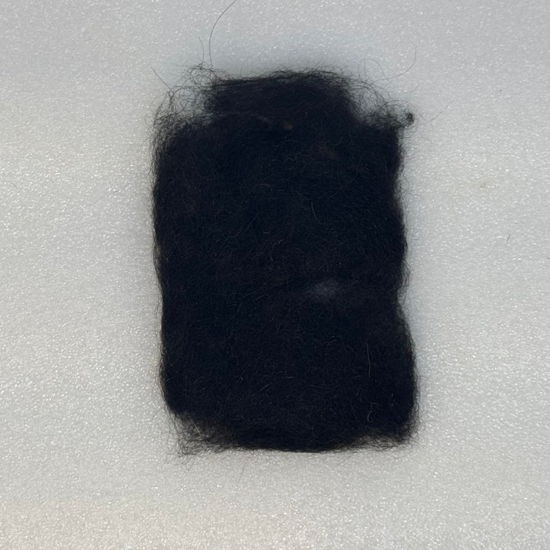 Black dubbing fibers clump
