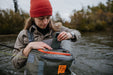 An angler with the sling on her front using the Stormshadow Sling Pack