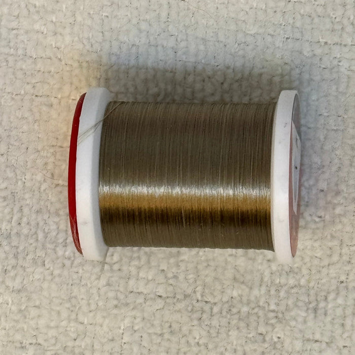 Close up spool tan colored ultra thread