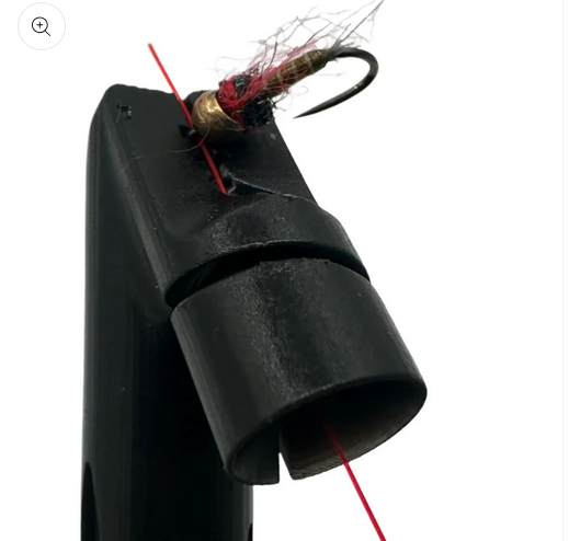 close up of the end of the Talweg Fly Roost being used to tie on a red bead head nymph