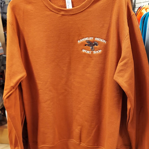 a rusty orange sweatshirt with the flying grouse and shop name design 