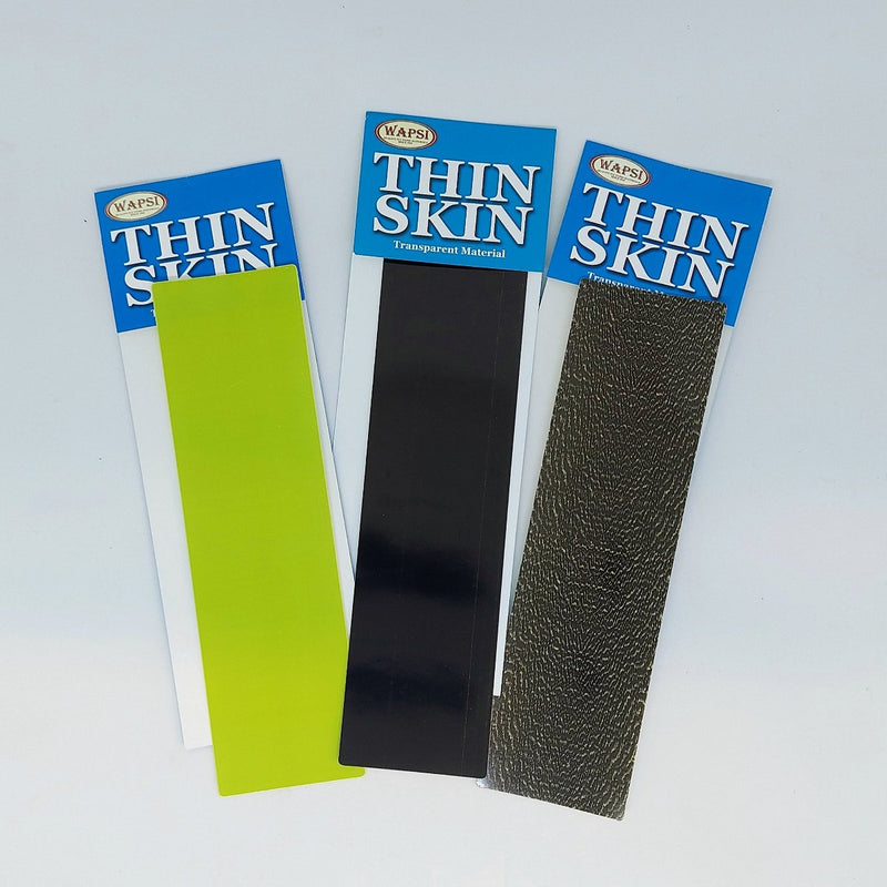Thin Skin transparent material sample packs with green, black, and dark gray strips
