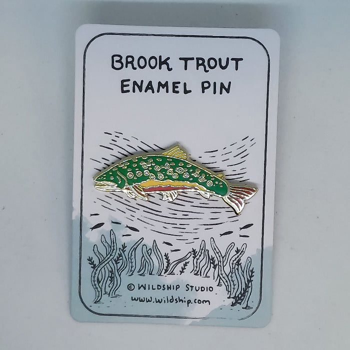 Brook trout enamel pin with green fish design on a backing card.