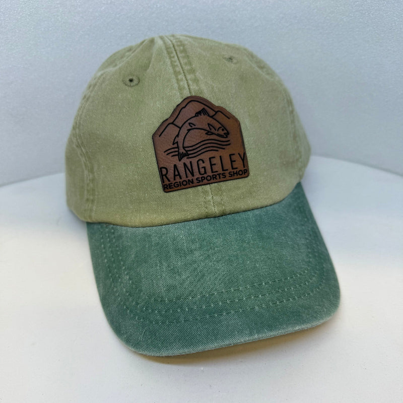 Khaki cap with green bill, brown leather patch logo on front