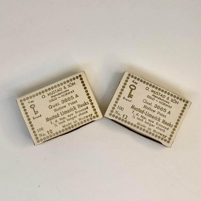 Two vintage boxes, side by side, of 10 and 12 Mustad hooks