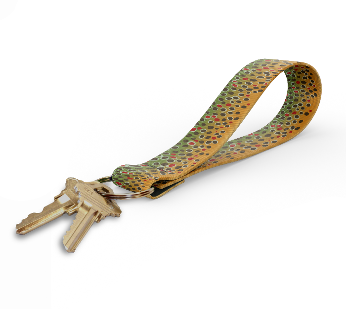 a key fob with a brown trout design on the strap