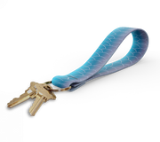 Key fob with blue wave-pattern strap and gold keyring, keys attached