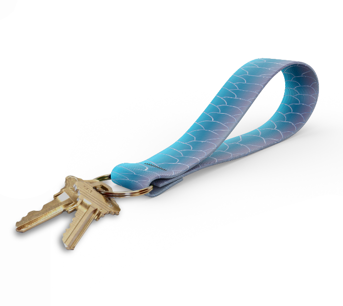 a key fob with a strap that has a tarpon skin design