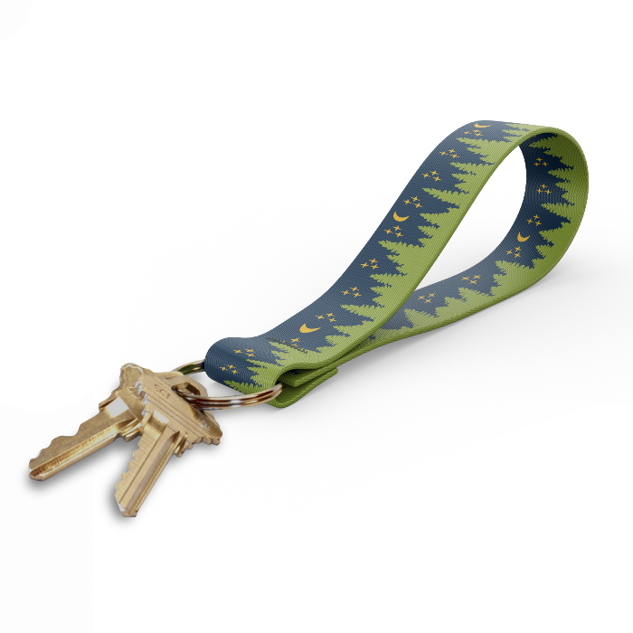 Key fob with green tree-pattern strap and gold keyring, keys attached