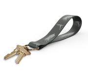 Key fob with dark gray leaf-pattern strap and gold keyring, keys attached