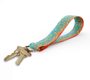 Key fob with bright multicolor dot-pattern strap and gold keyring, keys attached