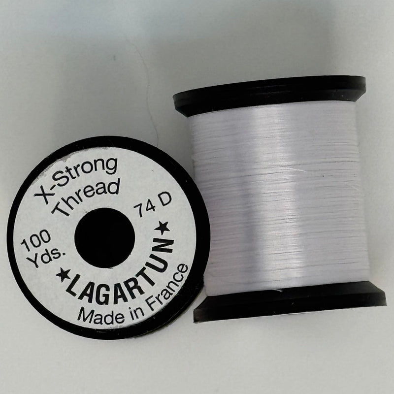 White thread spool with winding and circular label
