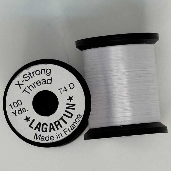 Spools of white thread from two angles side by side