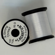 White thread spool with winding and circular label