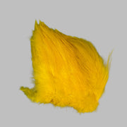 Strung neck hackle feathers, yellow with layered wispy fibers
