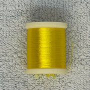 Four-strand floss spool in bright yellow