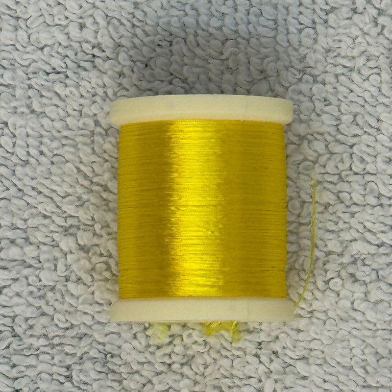 Four-strand floss spool in bright yellow
