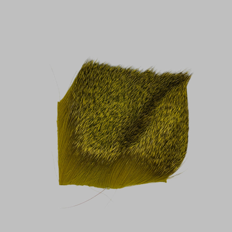 Yellow-green deer hair patch with dense fine fibers and trimmed edges