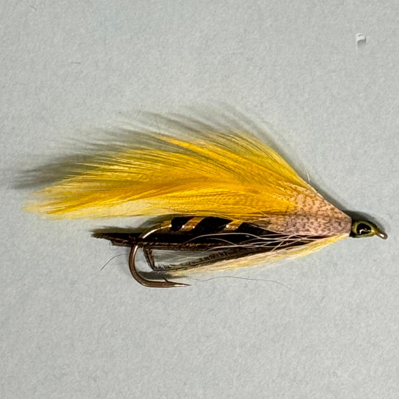 Yellow Ghost fishing lure with yellow feather tail, black-striped body, and metal hooks