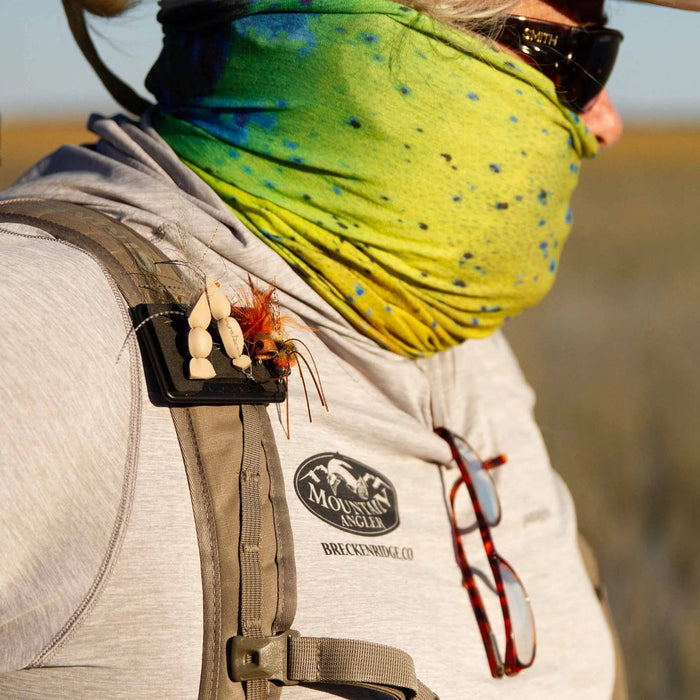 fly patch in use clipped to someone's pack strap
