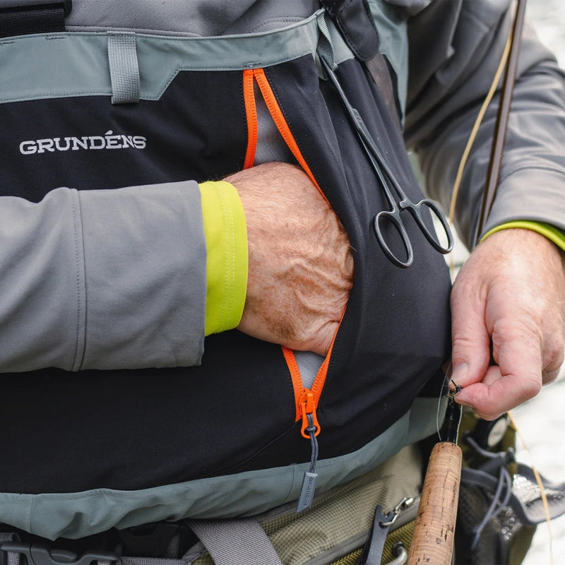 Men's stockingfoot waders hand pocket close-up with orange drawcord and black fabric