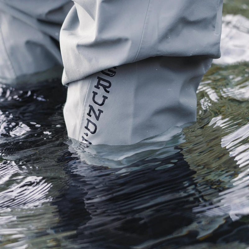 Men's stockingfoot waders submerged leg with GRUNDENS logo on gray fabric