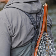 Men's stockingfoot waders shoulder area with orange-edged strap and hood panel