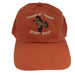 a burnt orange color ball cap with embroidered flying grouse and the shop name