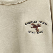 Tan crew neck sweatshirt with embroidered bird and text on chest