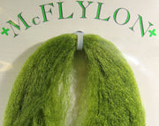 Yarn wig in bright green with tufted fringe and clip