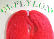 Yarn wig in red with tufted fringe and clip
