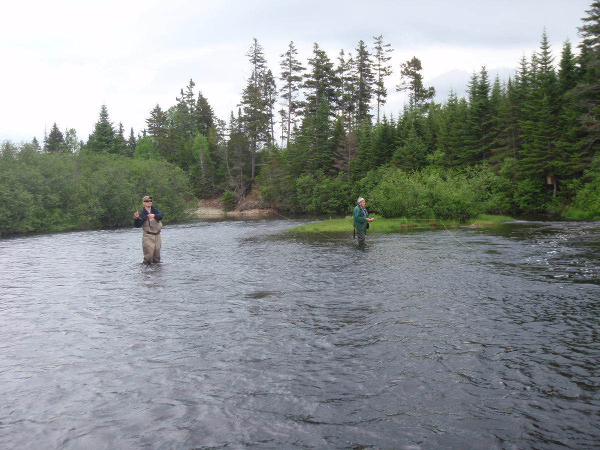 two people fishing a bend in a river with a registered maine guide in Rangeley 