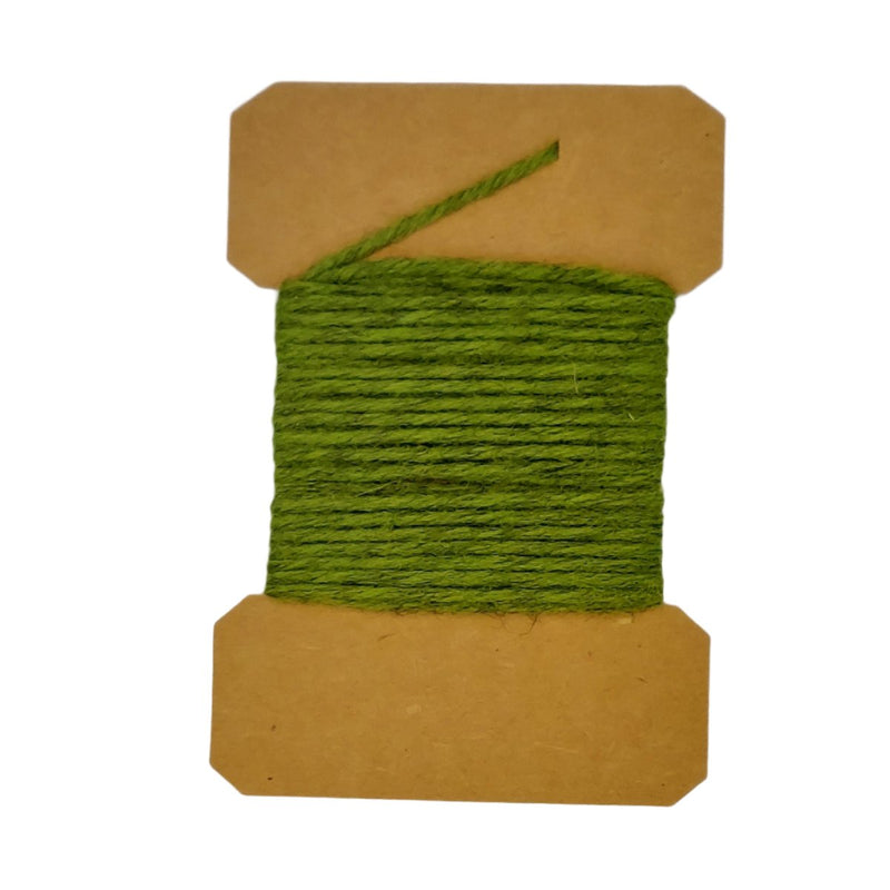 Wool yarn spool with olive green yarn wrapped on brown cardboard core.
