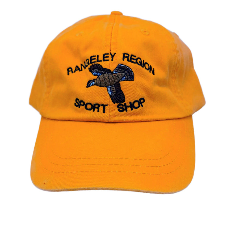 Flying Grouse hat, orange, embroidered flying grouse and Sport Shop lettering.